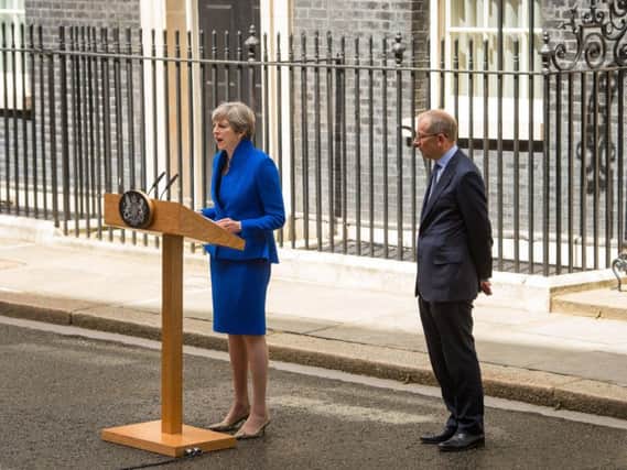 Prime Minister Theresa May, accompanied by her husband Philip, makes a statement in Downing Street after she travelled to Buckingham Palace for an audience with Queen Elizabeth II following the General Election results.Dominic Lipinski/PA Wire