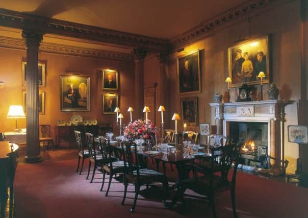 The formal dining room with family portraits