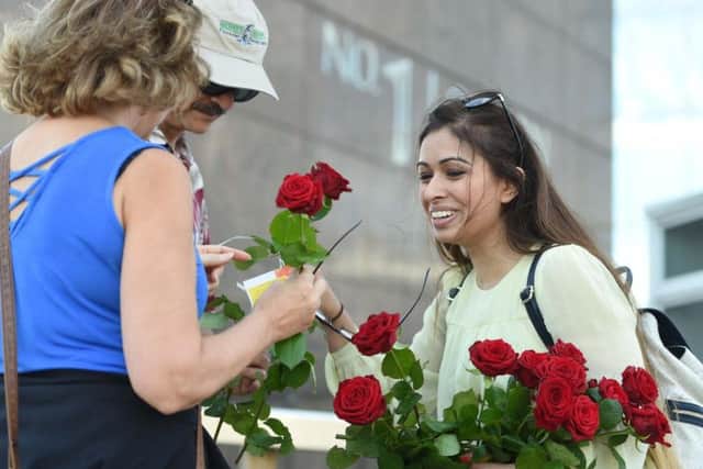 Roses with messages are given out to passers-by on London Bridge just over a week on from the terror attack on the bridge and at Borough Market. PA