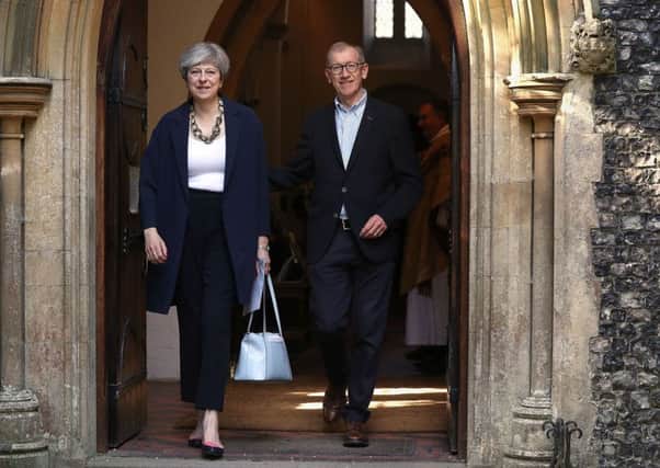 Theresa May and her husband Philip leave church yesterday morning in the Prime Minister's Maidenhead constituency.