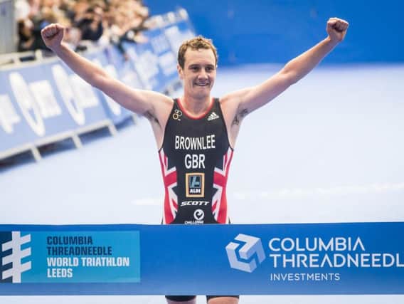 Alistair Brownlee raises his arms as he takes the tape in Leeds (Photo: PA)