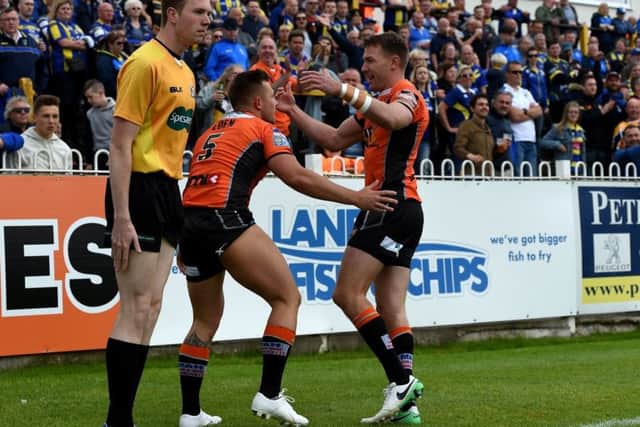 Tigers' Greg Eden with Michael Shenton after Eden scored the second of his first-half hat-trick.