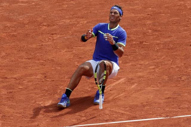 Rafael Nadal collapses to the ground after winning his 10th French Open title, defeating Stan Wawrinka in three sets at Roland Garros. Picture: AP/Christophe Ena