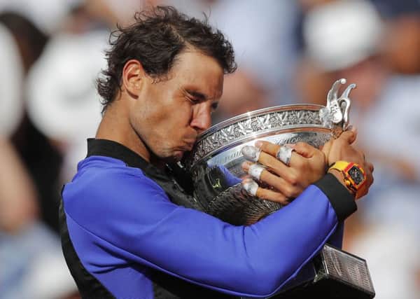 Spain's Rafael Nadal celebrates winning his 10th French Open title, defeating Stan Wawrinka in three sets at Roland Garros on Sunday. Picture: AP /Christophe Ena