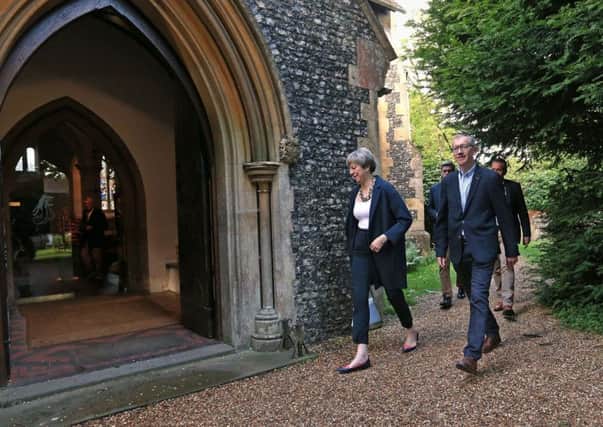 Theresa May and her husband Philip arrive at church.