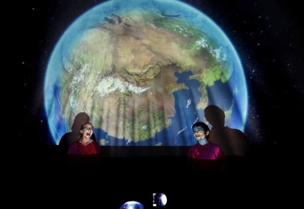 Ten year-olds Imogen Snowden and George Alderman at Carlton-in-Snaith primary school enjoy the new pop up planetarium developed by Drax. 
Picture: Jonathan Gawthorpe