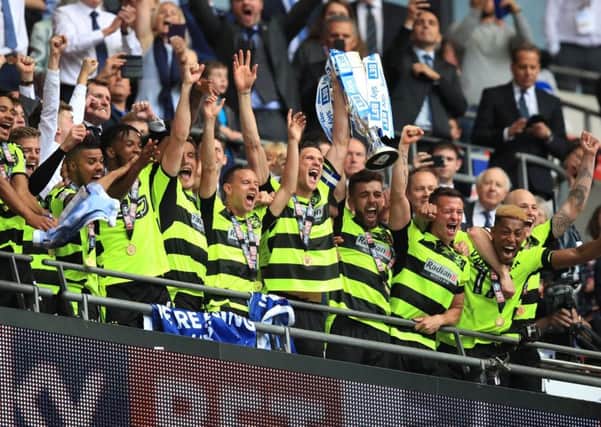 Huddersfield Town's players celebrate winning the Championship play-off final against Reading at Wembley, earning promotion to the Premier League. Picture: Mike Egerton/PA