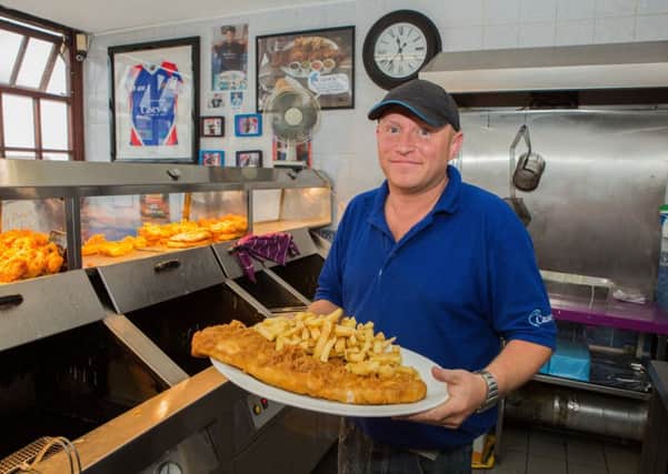 John Haggerston, 37, the owner of Casey's Fish Shop in Ossett, West Yorks. Casey's serves what they claim to be the UK's biggest fish and chips, consisting of a huge side of battered fish, a massive portion of chips, four sides and a bread bap.  Pic Benjamin Paul / SWNS.com