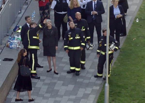 Theresa May during a visit to the scene of the Grenfell Tower tragedy.