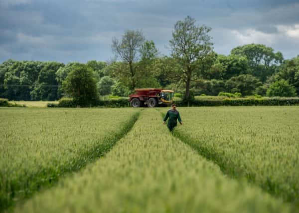 Jonathan Rycroft, a convert to farming with GPS, with the Lite Trac sprayer in the background. Picture by James Hardisty.