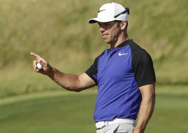 Paul Casey, of England, reacts after making a putt on the 12th hole