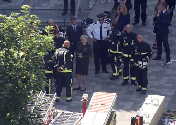 Theresa May at the scene of the Grenfell Tower tragedy. She met the emergency services, but not victims.