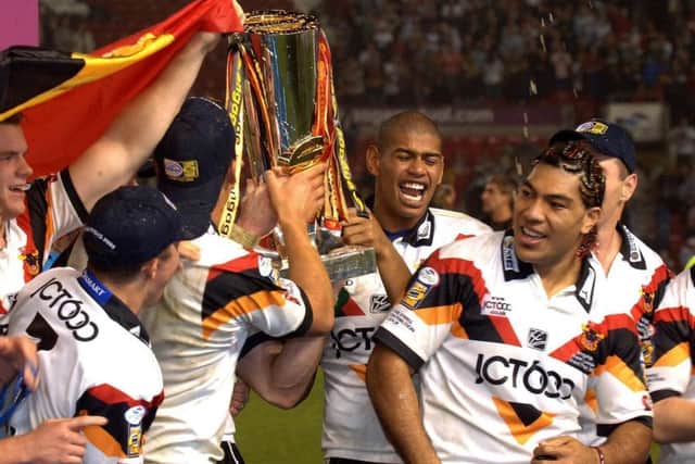 Bradford Bulls' Leon Pryce and Lesley Vainikolo (R) join the celebrations as they lift the trophy after defeating Leeds Rhinos in the Super League Grand Final at Old Trafford in October 2005. Picture: John Giles/PA.