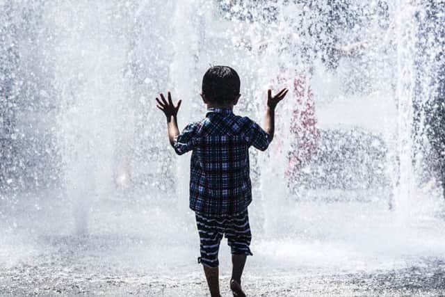 Children play in a water fountain in Bradford, Yorkshire, as Britain is set to bask in its hottest day of the year this weekend, with the fine weather continuing into next week.