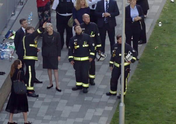 Theresa May at the scene of the Grenfell Tower disaster.