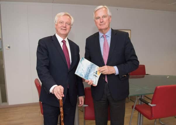 Department for Exiting the EU handout photo of Brexit Secretary David Davis exchanging mountaineering gifts with European Commission's chief negotiator Michel Barnier at the commission's Berlaymont headquarters in Brussels, Belgium,  during the first day of Brexit negotiations.
