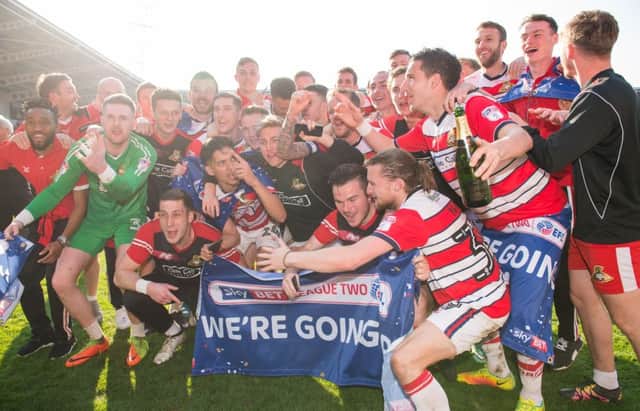 Doncaster Rovers players celebrate promotion from League Two. Picture: Jon Buckle/PA
