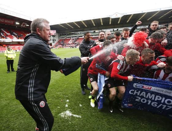 TOP SEASON: Sheffield United manager Chris Wilder sprays champagne over his players after clinching the League One title. Picture: Simon Bellis/Sportimage