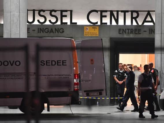 Police investigators and members of the DOVO (bomb clearing squad) work inside Central Station in Brussels after a reported explosion on Tuesday. Picture: (AP Photo/Geert Vanden Wijngaert)