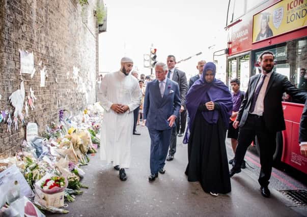 The Prince of Wales visits tributes left at the scene of the Finsbury Mosque attack alongside Imam Mohammed Mahmoud during a visit to Muslim Welfare House in north London.