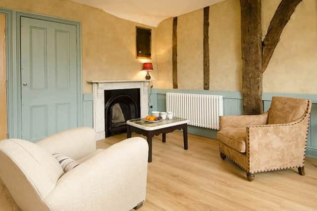 The sitting room with dappled walls and vintage French furniture