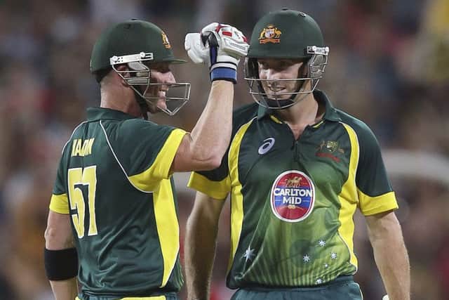 Shaun Marsh, right, with Brad Haddin, celebrates a one-day win for Australia over England at Sydney in January 2014. Picture: AP/Rob Griffith.