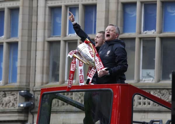 Sheffield United manager Chris Wilder pictured with the trophy during the clubs open-top bus ride through the city after winning the League One title.