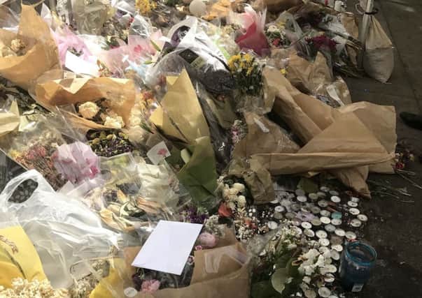 Tributes left near to the Grenfell Tower fire in west London. PIC: PA