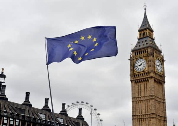 An EU flag flies in front of the Houses of Parliament in Westminster, London. Photo: Victoria Jones/PA Wire