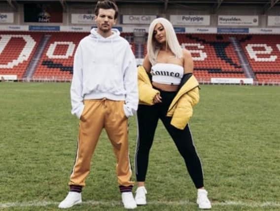 Louis Tomlinson and Bebe Rexha on the Keepmoat pitch. (Photo: Louis Tomlinson/Instagram).