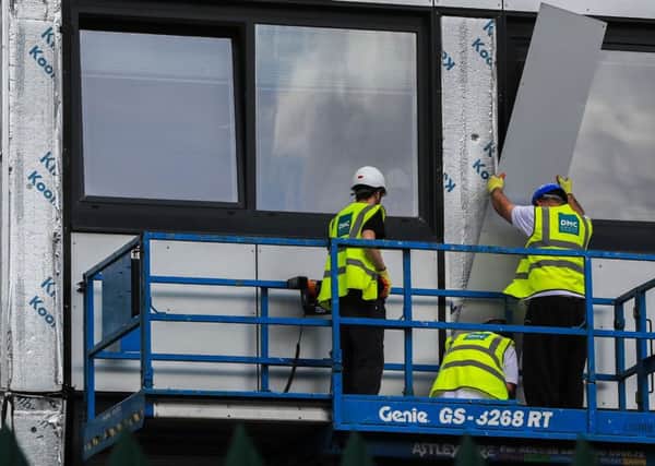 Cladding is removed from a block of flats in Manchester in the wake of the Grenfell tragedy.