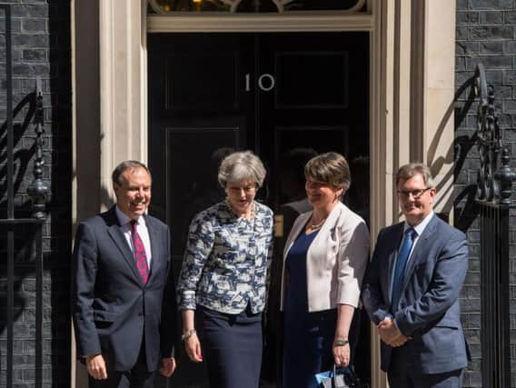 Prime Minister Theresa May greets DUP leader Arlene Foster, DUP deputy leader Nigel Dodds and DUP MP Sir Jeffrey Donaldson outside 10 Downing Street in London ahead of talks aimed at finalising a deal to prop up the minority Conservative Government.