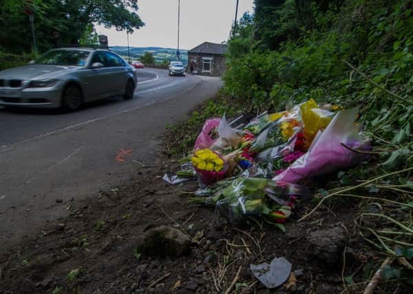 Floral tributes at the scene of the fatal incident on the A660 Leeds Road, Pool In Wharfedale, near Leeds.  Pictures by James Hardisty.