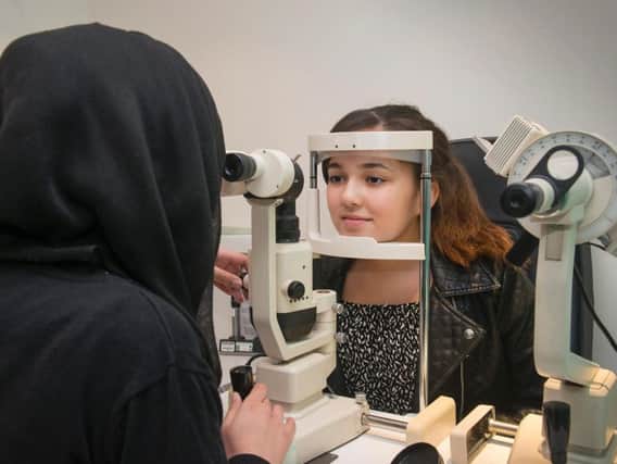 An eye test revealed Niamh Kane had a benign tumour. She is being tested by optometrist Misbah Jabeen