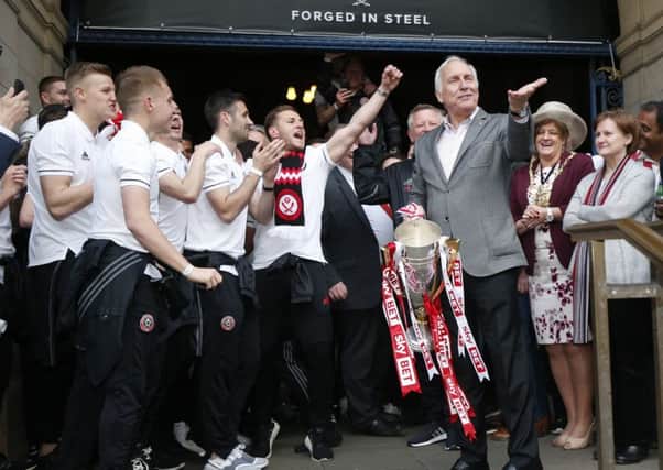 Co Owner Kevin McCabe celebrates winning the League One title with players and fans. Picture: Simon Bellis/Sportimage
