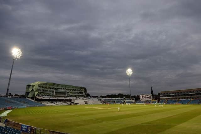 The floodlights come on for the evening session at Headingley on Monday. Picture: Anna Gowthorpe/PA