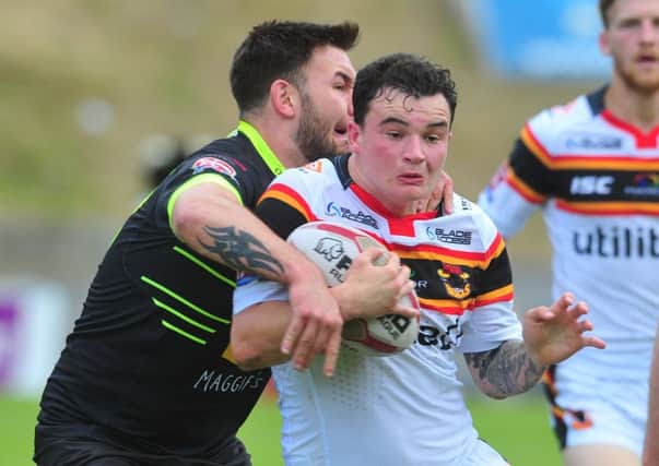 HEADING BACK: Jordan Lilley tackled by Oldham's Benjamin Davies last weekend while playing for Bradford Bulls. Picture Tony Johnson.