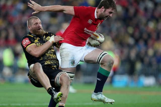 British and Irish Lions' Iain Henderson is tackled by Hurricanes Brad Shields. Picture: David Davies/PA.