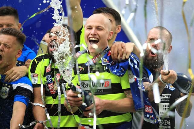 Going up: Huddersfield Town's Aaron Mooy celebrates winning the Sky Bet Championship play-off final at Wembley.