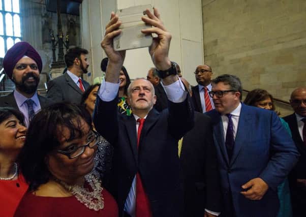 Labour leader Jeremy Corbyn takes a selfie with Labour MPs in Westminster Hall in the Houses of Parliament.