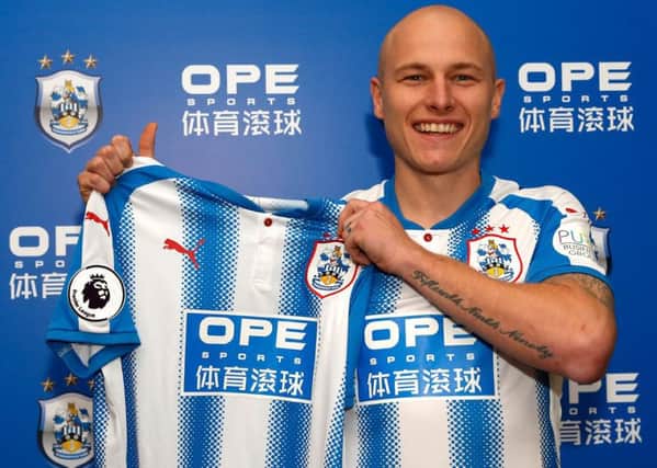 If the shirt fits: Aaron Mooy with the new Huddersfield Town kit after he signs three-year deal