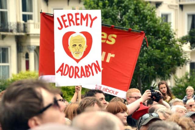 Supporters wave banners as Labour leader Jeremy Corbyn addresses a rally in Warrior Square Gardens, Hastings, East Suusex. Picture: Ben Mitchell/PA Wire