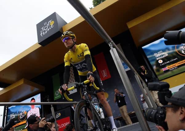 Britain's Geraint Thomas wearing the overall leader's yellow jersey arrives for the start of the second stage of the Tour de France.