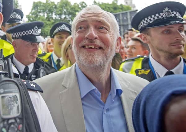 Labour leader Jeremy Corbyn is mobbed by the crowd after addressing an anti-austerity rally in Parliament Square, London, following a march through the city as part of an anti-austerity protest.