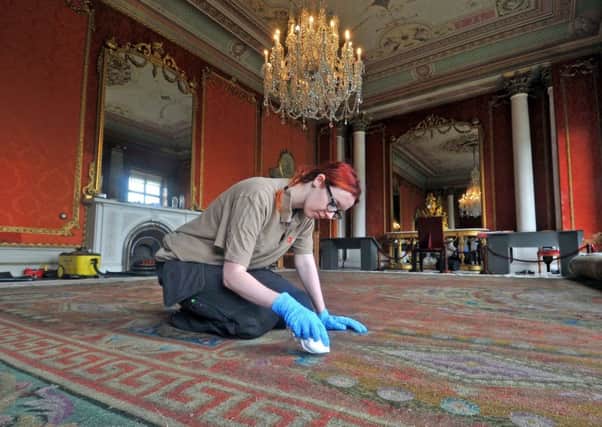 Bethany Ronksley carefully takes 150 years worth of dirt from one of Brodsworth Halls finest carpets.
