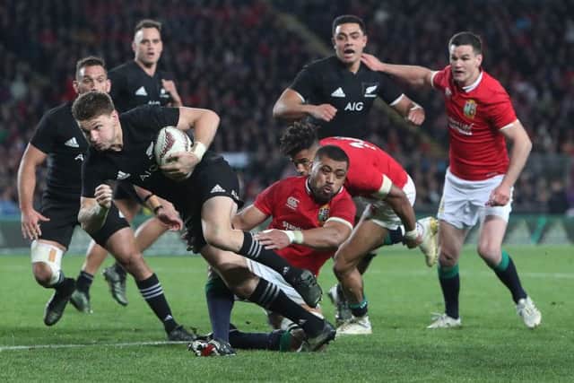 Taulupe Faletau gets in a challenge on New Zealand's Beauden Barrett . Picture: David Davies/PA