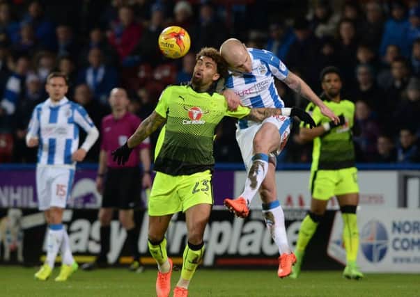 Aaron Mooy beats Reading's Danny Williams to the ball.
 The two will be team-mated next season in the Premier League.  Picture: Bruce Rollinson