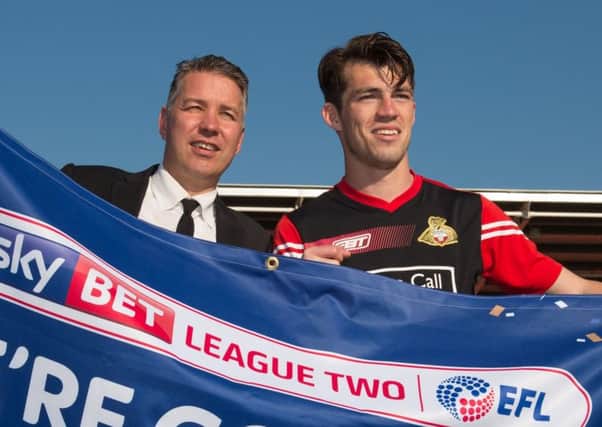 Doncaster Rovers manager Darren Ferguson celebrates promotion with John Marquis.