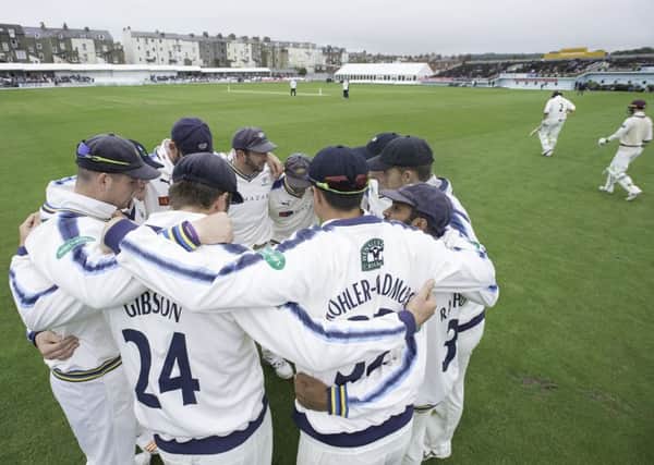 Yorkshire's team huddle as Somerset's opening batsman come out for the start of their second innings at Scarborough.