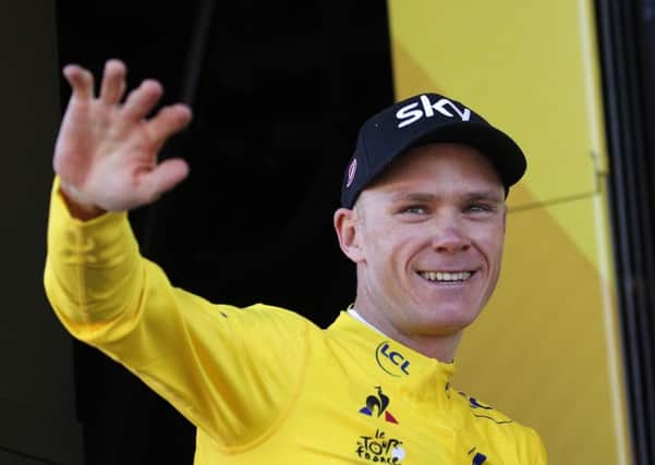 Britain's Chris Froome, wearing the overall leader's yellow jersey, celebrate on the podium after the fifth stage of the Tour de France. Picture: AP/Christophe Ena
